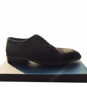 Handmade black suede captoe Oxford shoes with closed-lacing design, crafted for men’s weddings, business wear, and formal occasions.