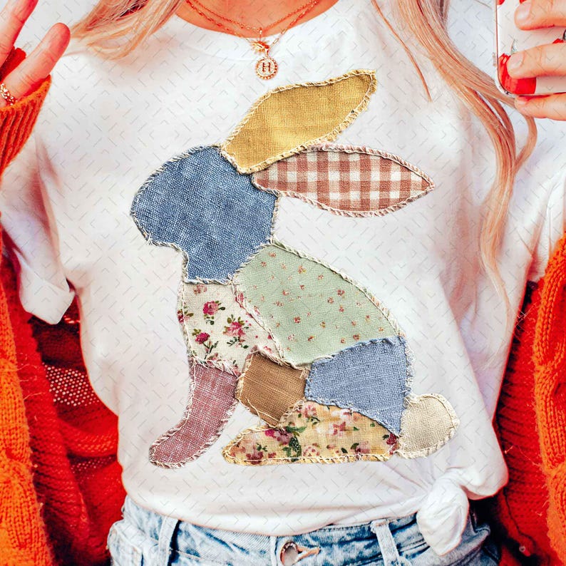 May include: White t-shirt featuring a patchwork bunny design. The bunny is composed of various fabric patterns, including floral, gingham, and solid colors. The shirt is a casual style, suitable for everyday wear.