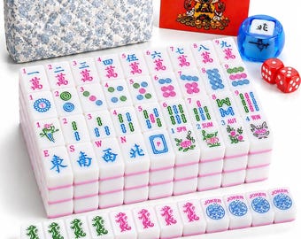 May include: A Mahjong set featuring white tiles with colorful Chinese characters, numbers, and symbols, a blue translucent wind indicator, two red dice, four stacks of colored plastic chips, a floral quilted carrying case, and a red instruction card.