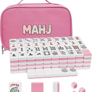 May include: A Mahjong set featuring white tiles with pink backs and colorful character, bamboo, and dot markings. The set includes a pink zippered carrying case with the text MAHJ printed on the front, along with three pink dice and extra tiles.