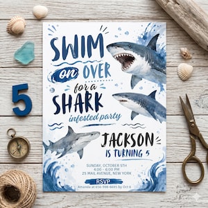 May include: A white invitation with blue watercolor sharks and text that reads "Swim on Over for a Shark Infested Party." The invitation is for Jackson's 5th birthday, with event details and RSVP information.