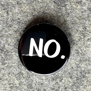 May include: A black button with the word "NO" in white lettering.