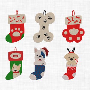 May include: A collection of six Christmas ornaments with a dog theme. The ornaments include red and green stockings, a bone-shaped ornament, and dog-themed designs such as paw prints and dog faces. Each ornament has a loop for hanging.