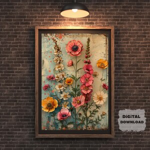 May include: A framed floral art print featuring a variety of colorful flowers, including pink poppies and yellow blooms, against a light blue and cream background. The artwork is set in a dark brown wooden frame, creating a striking contrast. The words "DIGITAL DOWNLOAD" are in the bottom right corner.