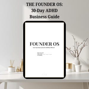Pode incluir: Uma impressão branca emoldurada com texto preto que diz "THE FOUNDER OS: 30-Day ADHD Business Guide." Abaixo, o texto "FOUNDER OS" é exibido, seguido por "Your Operating System for Building Different." A impressão está em uma superfície branca.