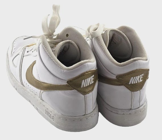 white nike basketball shoes with gold swoosh