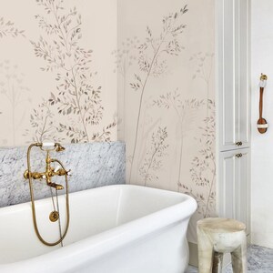 May include: A luxurious bathroom with a white clawfoot tub, marble accents, and a botanical wallpaper design. The brass faucet adds a touch of elegance. A small wooden stool sits nearby, complementing the room's serene aesthetic.