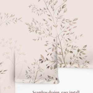 May include: A roll of wallpaper featuring a watercolor design of tree branches and leaves in shades of brown, beige, and gray. The background is a light beige color. The text "Seamless design, easy install" is visible.