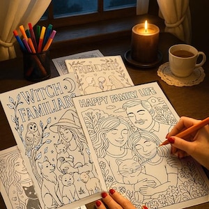 May include: A cozy scene with coloring pages, colored pencils, and a lit candle. The pages feature line drawings with themes like "Witch Familiars" and "Happy Family Life." A hand with red nail polish is coloring a page.