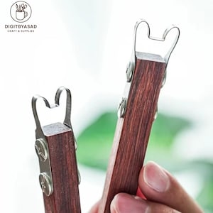 May include: Two wooden craft tools with metal accents. The tools have a dark wood finish and a curved metal piece at the top. The tools are held in a person's hand. The logo "DIGITBYASAD CRAFT & SUPPLIES" is in the top left corner.