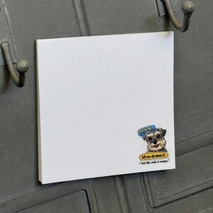 May include: A square white notepad with a cartoon dog sticker. The sticker has a dog with the text "Oh Wow" in a speech bubble and "Tell me all about it. But like, make it snappy." in a yellow circle.