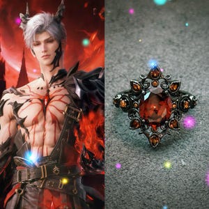 May include: A dark metal ring with a large, round, reddish-orange gemstone at the center. The ring is adorned with smaller, similarly colored stones and intricate filigree detailing. The ring's design is symmetrical and ornate, with a vintage or fantasy aesthetic.