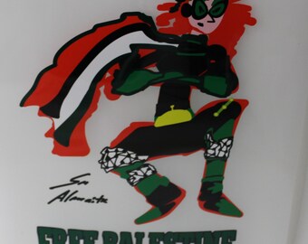 May include: A vibrant illustration of a figure in a black outfit with green and white details, a red and white cape, and a black hat. The words "FREE PALESTINE" are at the bottom, with the artist's signature above.