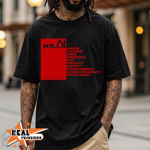 Peut inclure: T-shirt noir avec un motif rectangulaire rouge. Le motif comprend les mots "AI KILLS" et une liste de mots en rouge, dont "MINDS", "JOBS" et "PRIVACY". Le texte "Support people" est également inclus.