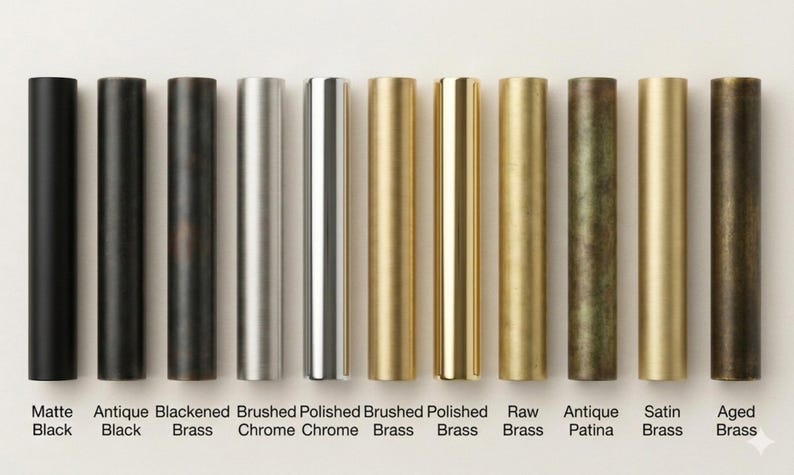 May include: A collection of cylindrical metal hardware samples in various finishes, including matte black, antique black, blackened brass, brushed chrome, polished chrome, brushed brass, polished brass, raw brass, antique patina, satin brass, and aged brass. Each sample is labeled with its finish name.