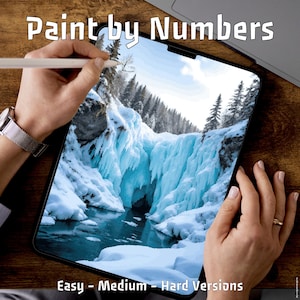 May include: A digital paint-by-numbers project displayed on a tablet, featuring a winter landscape with a frozen waterfall and snow-covered trees. The text "Paint by Numbers" is at the top, with "Easy - Medium - Hard Versions" at the bottom.