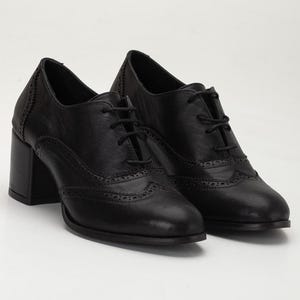 May include: A pair of black leather Oxford-style shoes with a block heel. The shoes feature decorative perforations along the toe and sides, and are laced up with black laces. The heels are approximately 3 inches high.