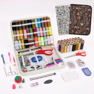 May include: A sewing kit containing a range of coloured thread spools, needles, scissors, and other sewing accessories. The kit includes a zipped case, and a floral patterned case. The kit is ideal for sewing projects.