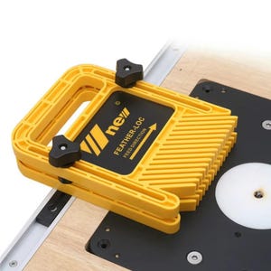 May include: A yellow Feather-Loc featherboard with black knobs and a black label. The label has the text "new" and "FEATHER-LOC FEED DIRECTION". The tool is designed to guide wood during cutting and is mounted on a wooden surface.