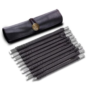 May include: A set of wood carving tools with black wrapped handles and silver blades, displayed with a black leather roll-up case. The case is secured with a brown cord and a decorative gold-colored button.