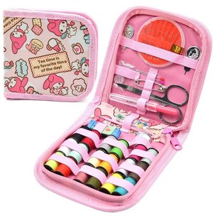 May include: A pink sewing kit with a zippered case and a matching small pouch. The kit contains spools of thread, needles, scissors, and other sewing notions. The pouch has a pattern with cartoon characters and the text "Tea time is my favorite time of the day!"