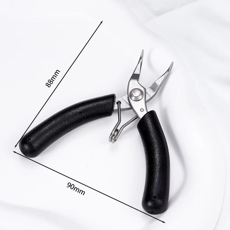 May include: Needle-nose pliers with black handles, measuring 90mm long and 88mm wide. The pliers are made of silver metal and are designed for precision work. The handles are curved for a comfortable grip. The tool is open, ready for use.