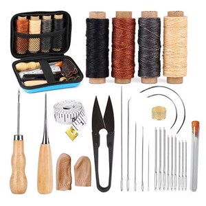 May include: A leathercrafting kit with various tools and supplies. Includes spools of black, brown, gray, and beige thread, needles, scissors, a tape measure, and a blue zippered case containing additional tools and thread.