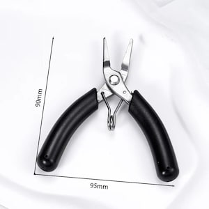 May include: A pair of silver-colored pliers with black handles. The pliers are 3.7 inches long and 3.5 inches wide. The tool has a spring and is designed for precision work. The handles are curved for a comfortable grip.