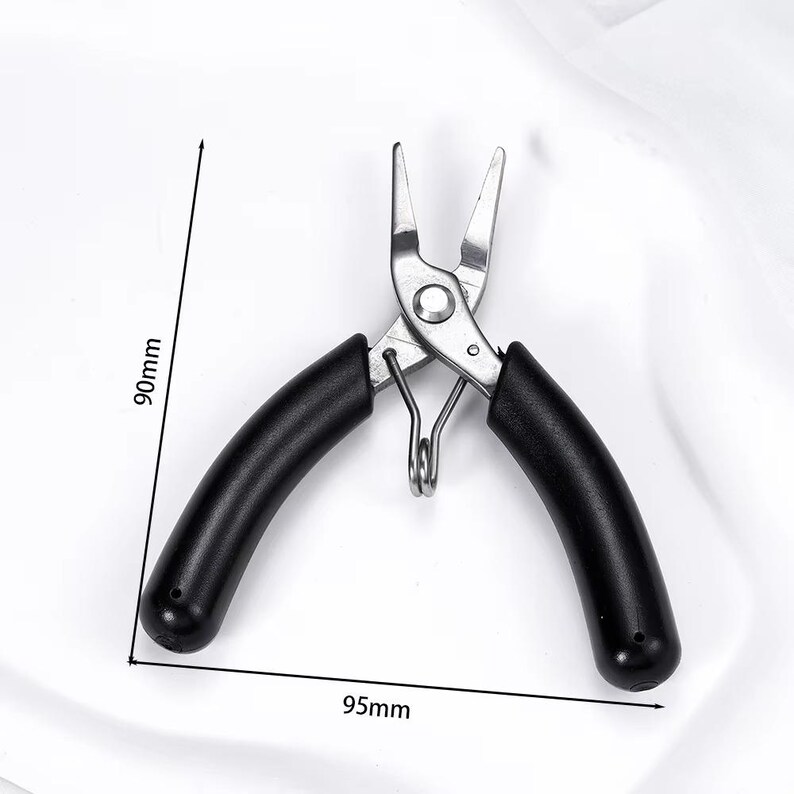 May include: A pair of silver-colored pliers with black handles. The pliers are 3.7 inches long and 3.5 inches wide. The tool has a spring and is designed for precision work. The handles are curved for a comfortable grip.