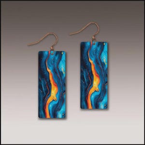 May include: A pair of rectangular earrings with a vibrant abstract design. The earrings feature a copper-colored hook and a blue, orange, and black swirling pattern. The design resembles flowing water or a fiery landscape.