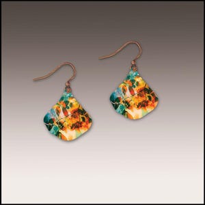 May include: A pair of copper-colored earrings with a colorful leaf design. The earrings have a diamond shape with a hook for pierced ears. The design features shades of orange, yellow, green, and blue.