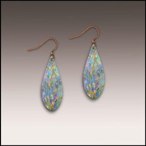 May include: A pair of teardrop-shaped earrings with a blue and multi-colored floral design. The earrings have copper-colored ear wires. The earrings are approximately 2 inches long.