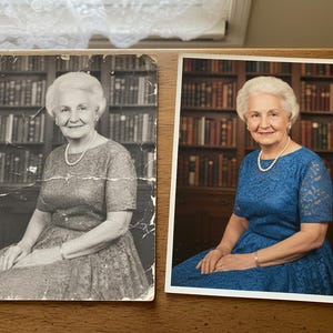 May include: Side-by-side portraits of a woman in a blue dress and a black and white version of the same photo. The woman has white hair and wears a pearl necklace and bracelet. A bookshelf is in the background.