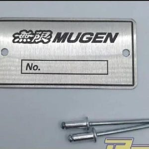 May include: A rectangular brushed metal identification plate featuring the text MUGEN and Japanese characters, with a designated box labelled No. for numbering. The plate includes two circular mounting holes and is accompanied by two metal rivets.