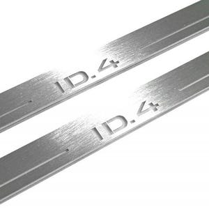 May include: Two brushed metal strips with the text "ID.4" etched into the surface. The strips are rectangular with a groove running down the center. The background is white.