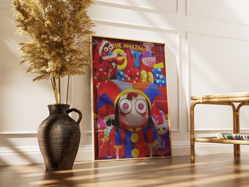 May include: A framed art print featuring a cartoon character with large eyes, wearing a jester-like outfit. The print has a red background with the words "THE AMAZING" at the top. A dark brown vase with dried plants sits to the left.