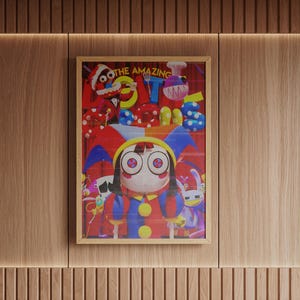 May include: A framed art print featuring a whimsical cartoon character with large eyes, wearing a red, blue, and yellow outfit. The artwork includes the text "THE AMAZING" and other colorful elements.