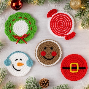 May include: A collection of five crocheted Christmas-themed coasters. Designs include a green wreath with a red bow, a red and white candy, a snowman with blue earmuffs, a gingerbread man, and a Santa Claus design with a black belt and gold buckle.