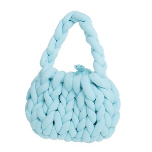 May include: A light blue, hand-knitted handbag with a braided handle. The bag's body is round and features a chunky knit design. The bag is made of a soft, plush material, perfect for carrying essentials.