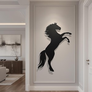 Könnte beinhalten: Schwarze Silhouette eines sich aufbäumenden Pferdes an einer Wand. Das Pferd befindet sich in einer dynamischen Pose, mit erhobenen Vorderbeinen. Die Wandkunst befindet sich in einem Flur mit neutraler Farbpalette und Holzböden.