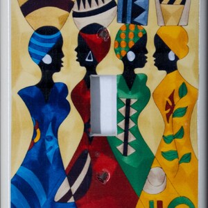 May include: Four women in colorful dresses with geometric patterns stand side-by-side. Each woman is wearing a headpiece with a different design. The background is a light yellow.