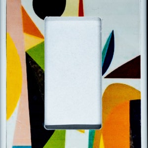 May include: A white light switch cover with a colourful abstract design featuring geometric shapes in shades of yellow, orange, green, blue, black, and pink.