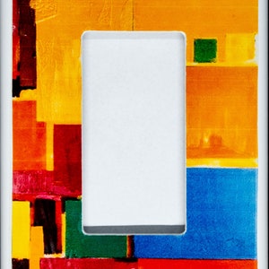 May include: A white light switch cover with a colourful abstract design featuring red, yellow, blue and green geometric shapes.