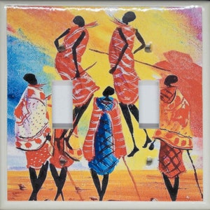 May include: A colorful light switch cover featuring an abstract painting of five figures in red, yellow, blue, and white. The figures are stylized and appear to be dancing or moving. The background is a vibrant yellow with hints of orange and blue.