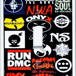 May include: A white light switch cover with a collage of logos from various hip hop artists, including Public Enemy, EPMD, Ice Cube, NWA, Wu-Tang Clan, Onyx, Das EFX, Nas, Run DMC, Redman, Cypress Hill, The Infamous, Mobb Deep, DMX, and Busta Rhymes. The text "Major Independents" is at the bottom of the cover.