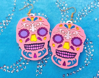 Colorful Pink Day of The Dead Skull Earrings with pastel pink Skull, mirror pink, glitter purple, pastel blue, and white acrylic details