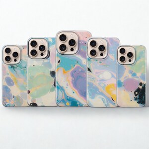 May include: Five phone cases with a colorful, abstract marble design. The cases feature a mix of pastel colors including blue, pink, yellow, and purple. Each case has a clear border around the camera and phone edges.