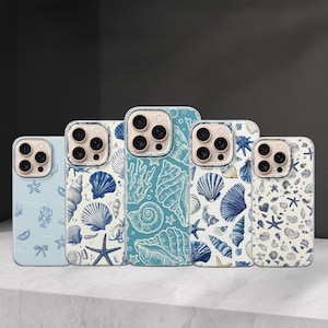 May include: A collection of phone cases with ocean-themed designs. The cases feature various patterns of seashells, starfish, and other marine life in shades of blue and white. The cases are displayed on a white surface.