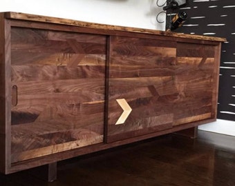 Walnut credenza with figured sliding doors and inlays.