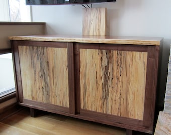 Entertainment center in a natural edge walnut.